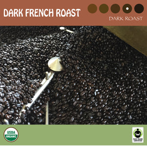 Dark french coffee beans in the roaster cooling bin. USDA organic and Fair Trade certified logos.